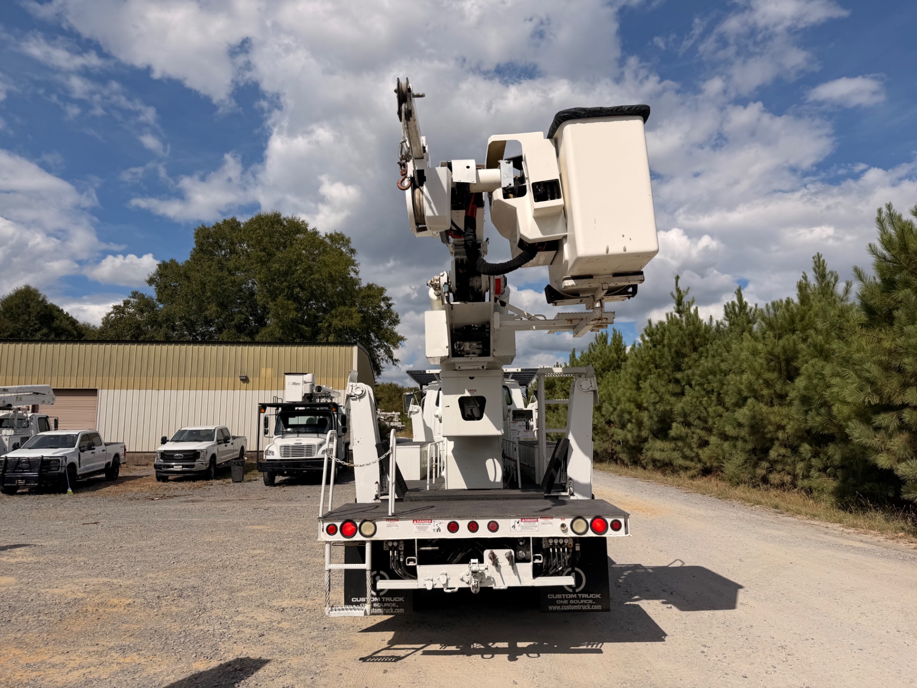 Rear view with elevated bucket and material-handling jib