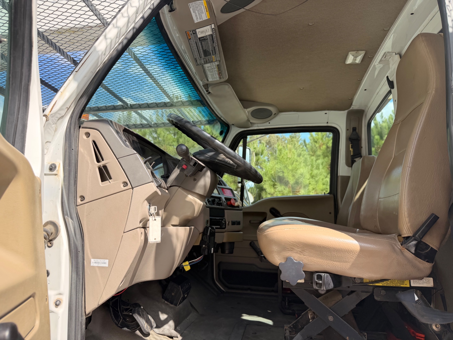 Cab interior with air-ride driver seat