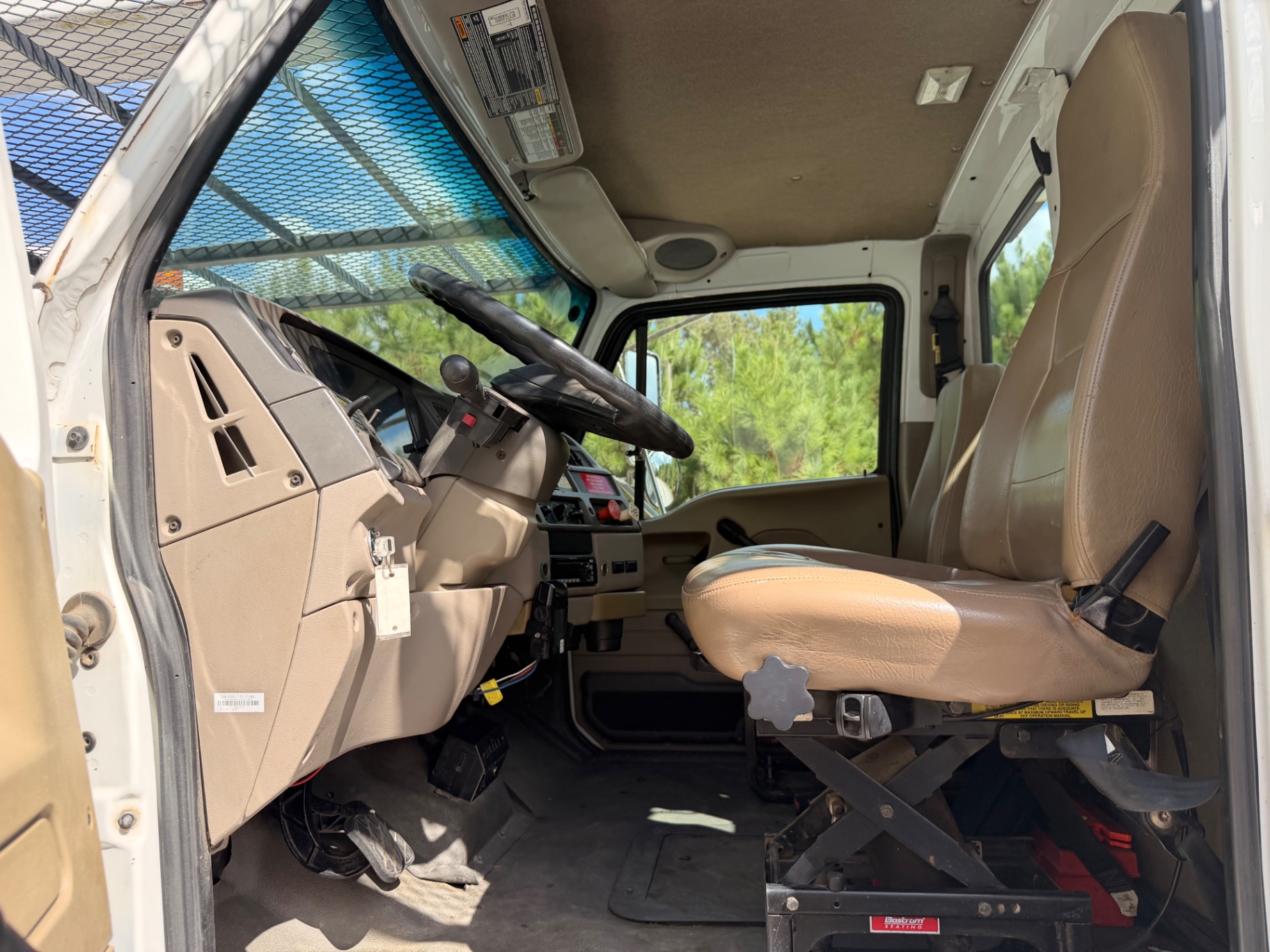 Cab interior, steering wheel, dashboard and passenger seat