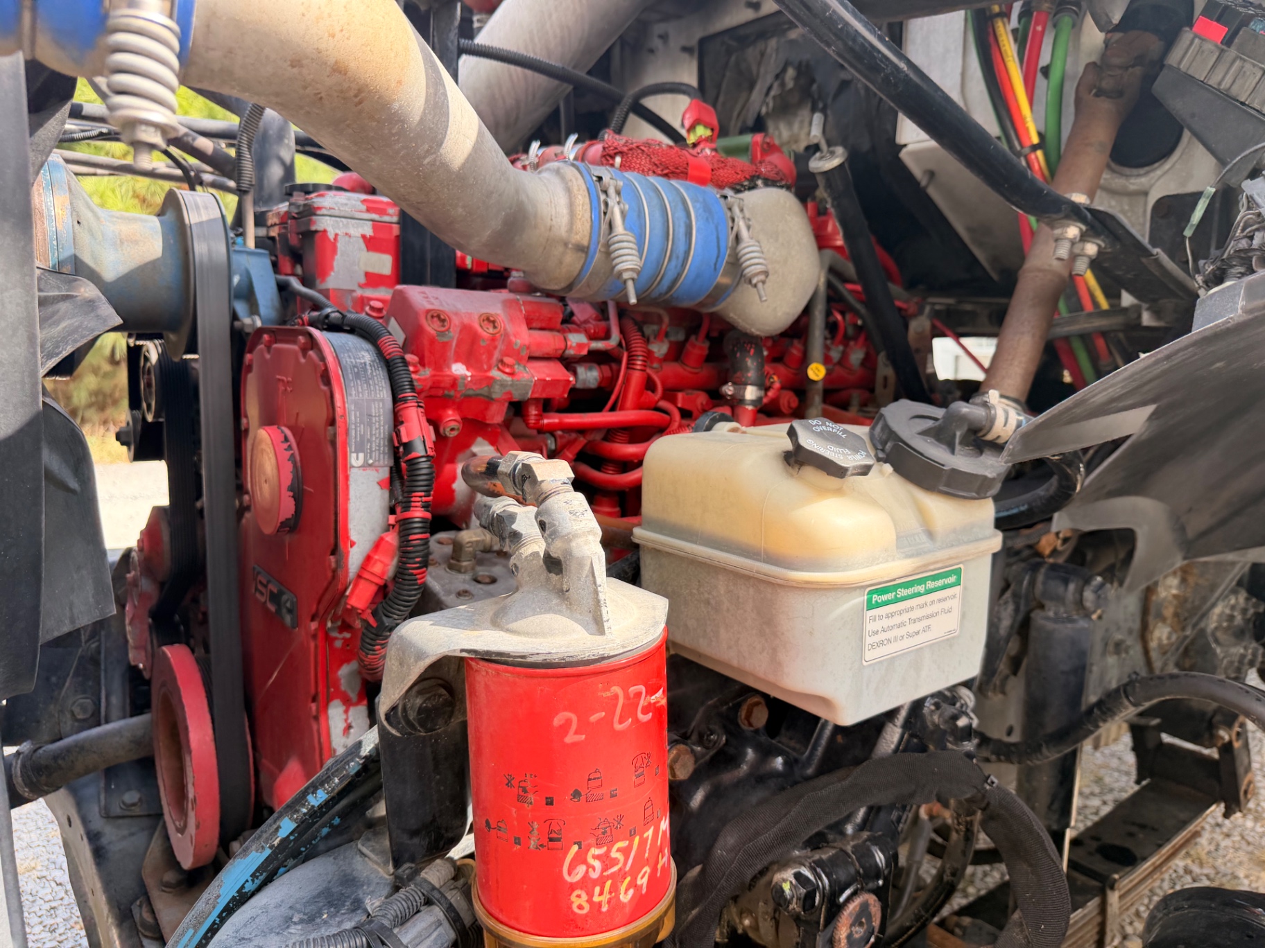 Engine bay close-up, filters and reservoirs